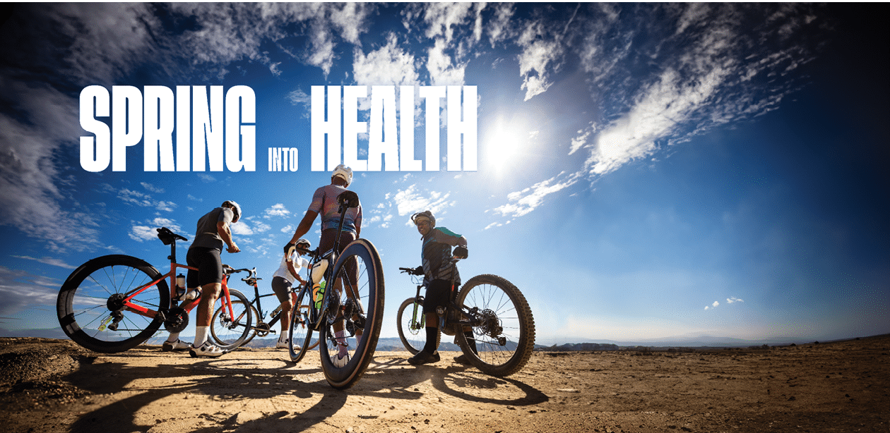 A group of middle-aged African-American men wearing lycra cycling clothes enjoying a morning ride on a sunny day in the Santa Monica Mountains in Malibu, California. They stop by a roadside vista point to enjoy the view.