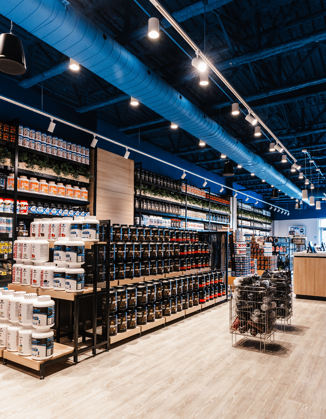 A large grocery store with a blue ceiling and aisles of products. Description generated by AI